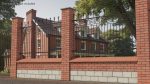 Brick and Metal Fence with Ornamental Ironwork