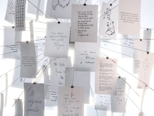Zettelz 5 light fixture with paper hanging from it