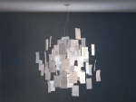 Zettelz 5 light fixture with paper hanging from it